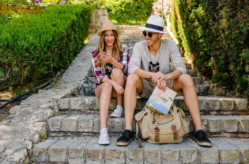 A couple sitting on concrete stairs outdoors